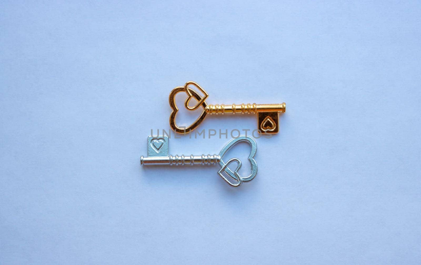 Gold and silver keys, with hearts isolated on a white background.