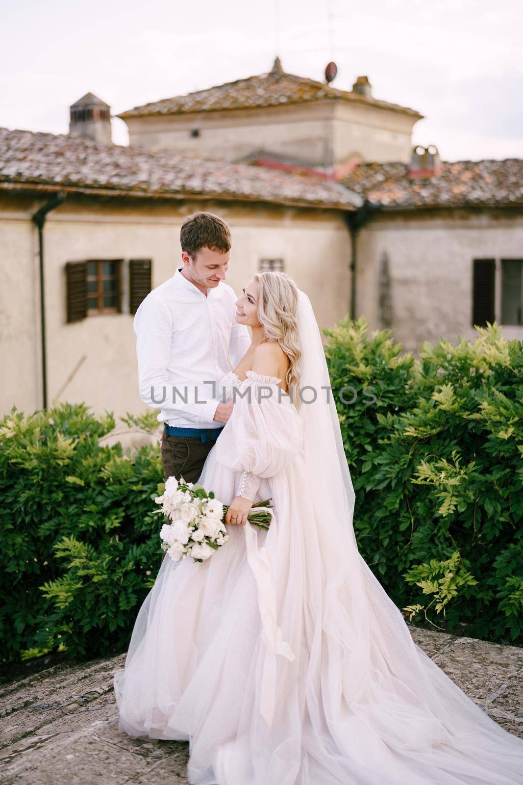 Wedding couple on the roof of an old winery villa. Wedding at an old winery villa in Tuscany, Italy.