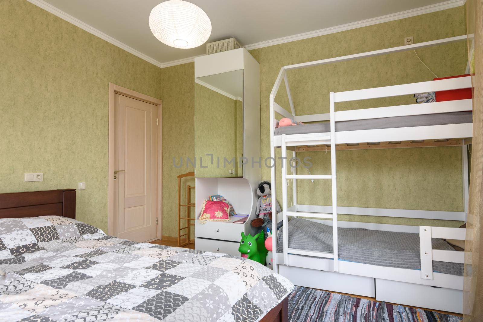 Bedroom interior with a large double bed and a children's bunk bed by Madhourse