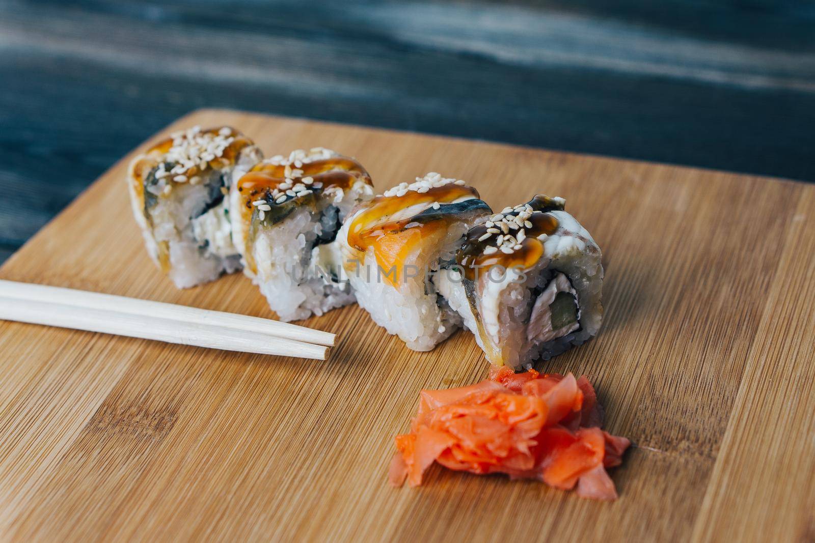 sushi rolls chopsticks japanese food wood board. High quality photo