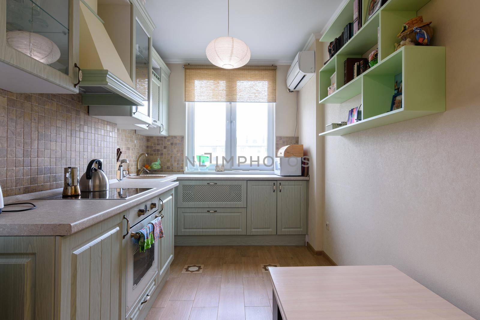 The interior of a light ordinary kitchen with a spacious kitchen set