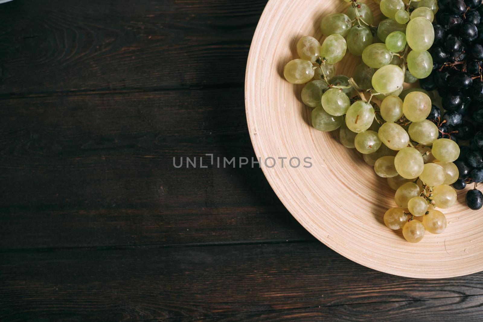 multicolored grapes on a plate vitamins fruit freshness organic. High quality photo