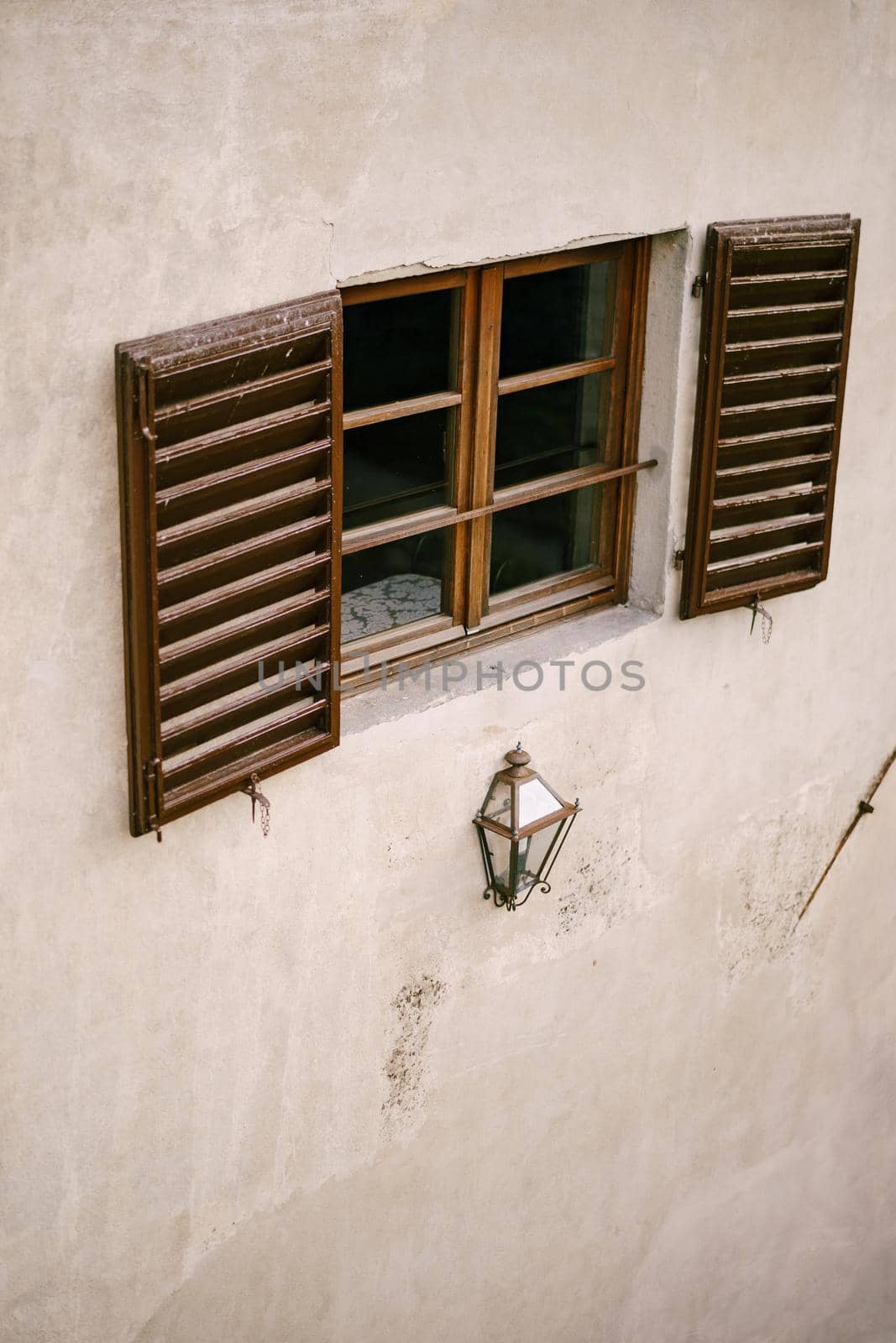 Wooden window made of brown wood and open window shutters