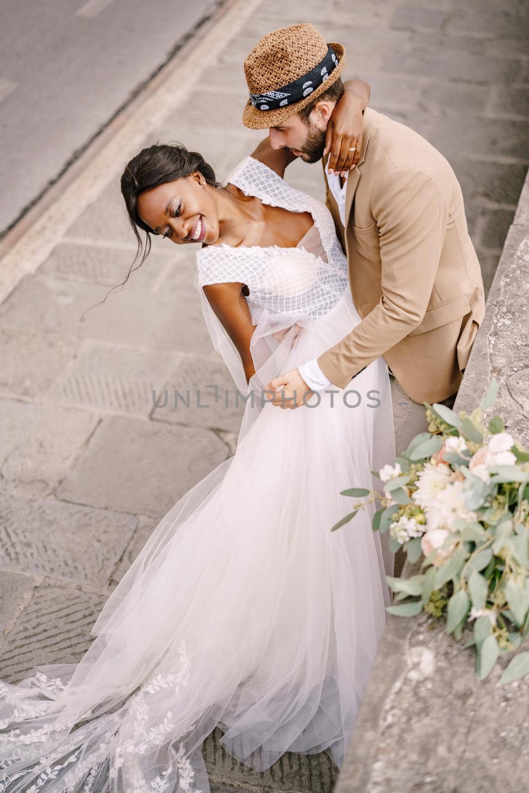 Interracial wedding couple. Wedding in Florence, Italy. African-American brid in white dress and Caucasian groom.