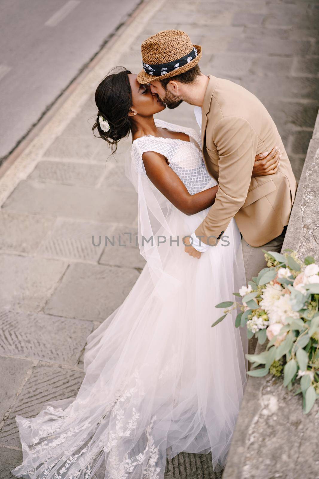 Interracial wedding couple. Wedding in Florence, Italy. African-American brid in white dress and Caucasian groom.