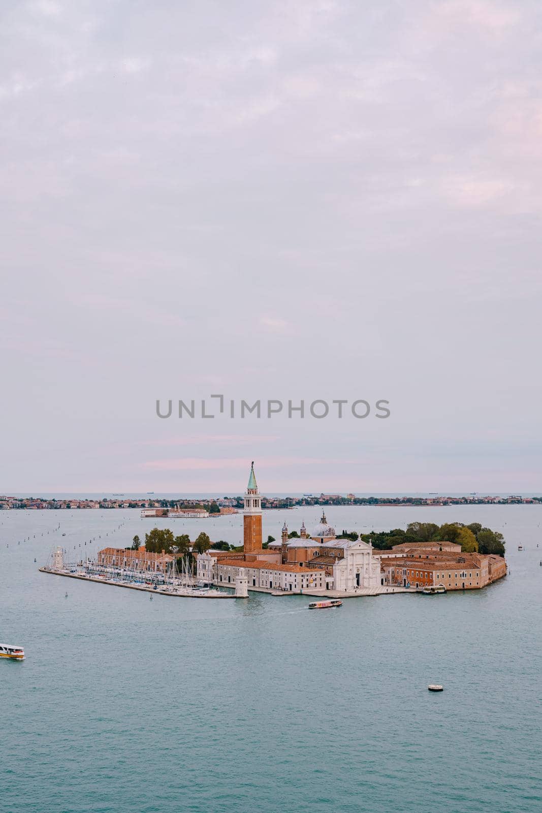 Aerial view from huge cathedral bell tower San Marco Campanile on San Giorgio Maggiore is one of most famous islands of the Venetian lagoon, in northern Italy.
