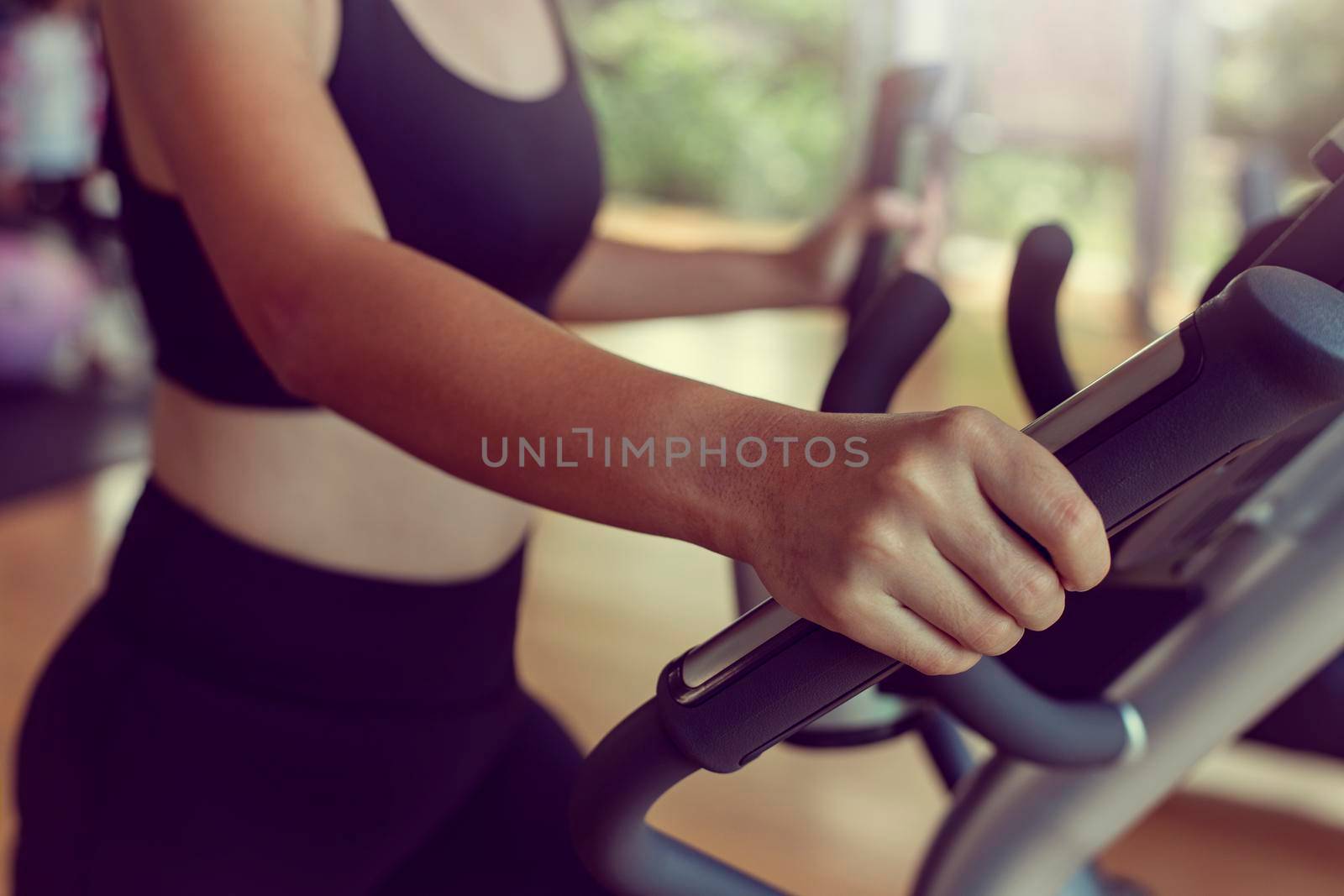 Close-up Sportwoman walking or running on treadmill equipment in fitness workout gym.Concept fitness ,workout, gym exercise ,lifestyle and healthy. by thanumporn