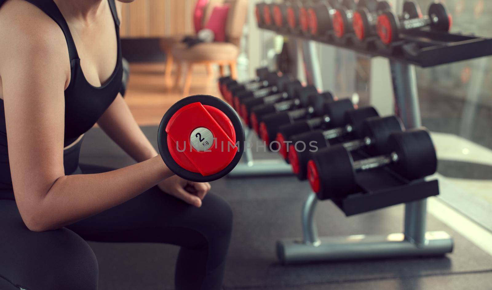 Young woman lifting weights on training class at gym. Concept fitness ,workout, gym exercise ,lifestyle and healthy.