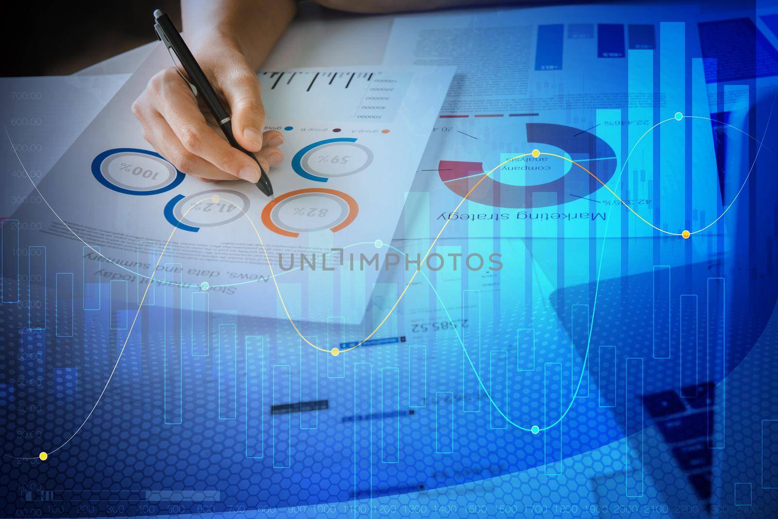 Close up hand Businesswoman holding pen and pointing at financial paperwork and planning investment for business and stocks. Financial forecast graph hologram. Double exposure.