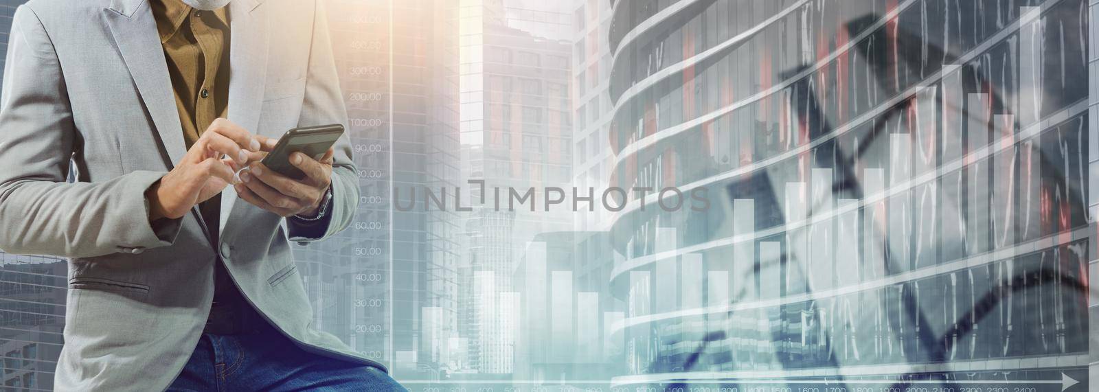 Businessman using the phone with bar graph and cityscape background.