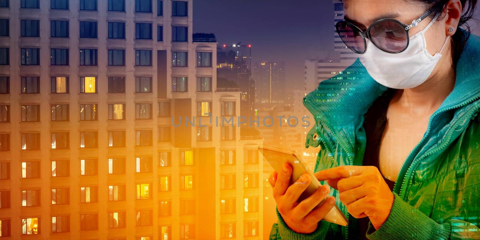 A tourist wearing a mask and using the phone isolated on night city background. Promoting people use face mask to protect themselves from virus infection in Corona virus crisis 2020