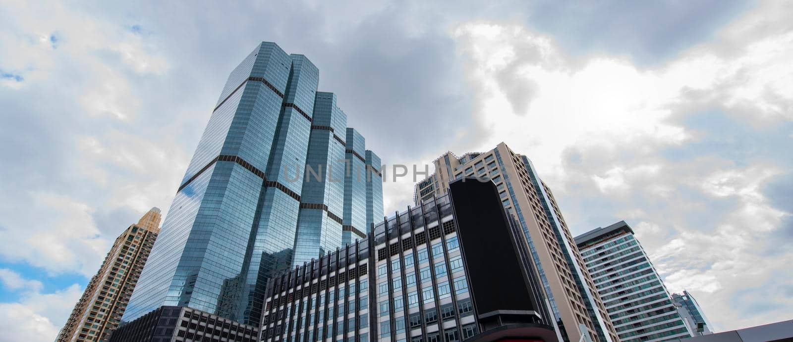 Bottom view of modern skyscrapers in business district. by thanumporn