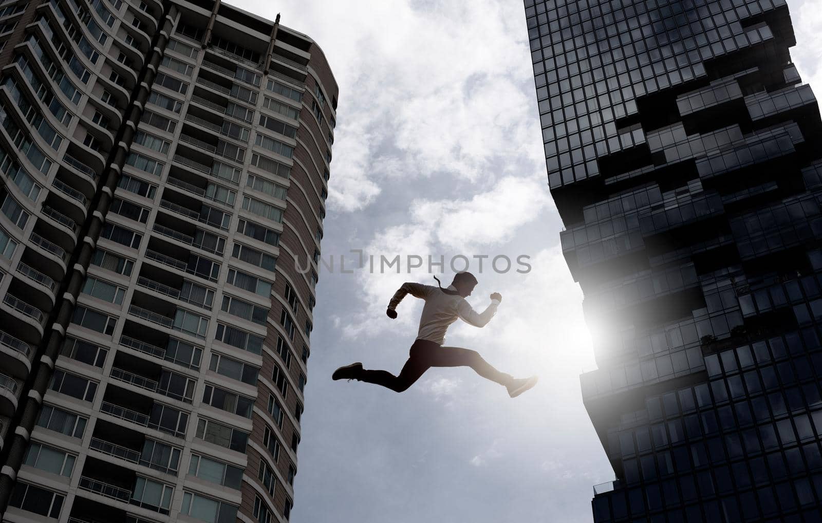 Young businessman jumping high, Work, job, or successful business concept. Cityscape background. by thanumporn