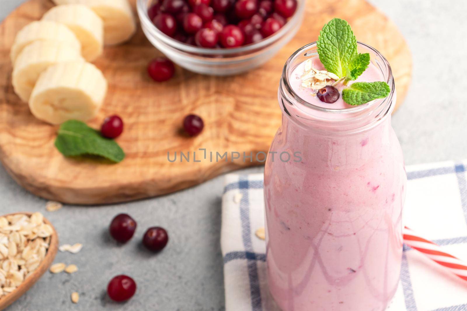 Homemade yogurt smoothie with banana, cranberry and oatmeal.