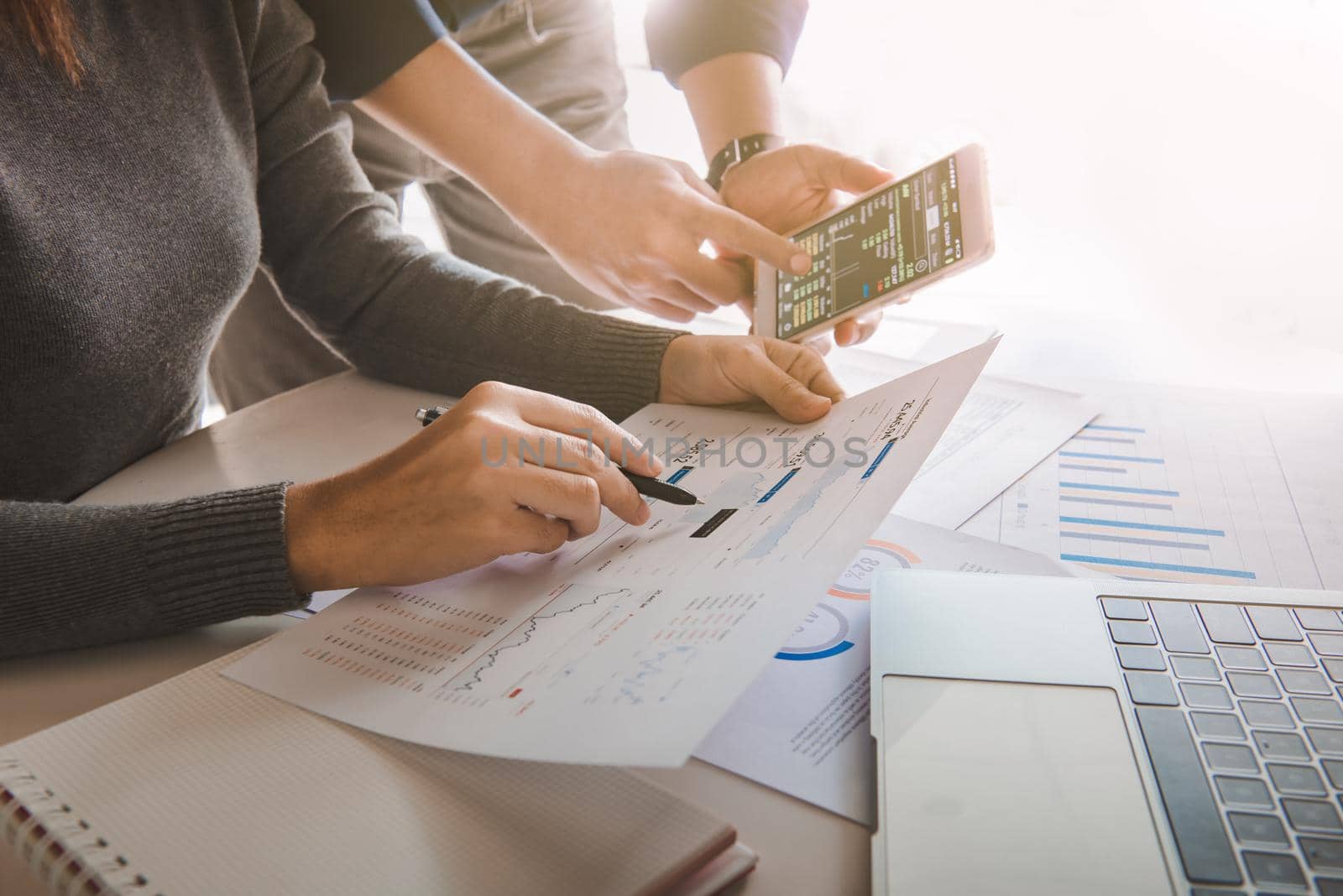 Business team analyzing sales data and economic growth graph chart on office table with laptop and smart phone, Brainstorming, Business strategy and planning.