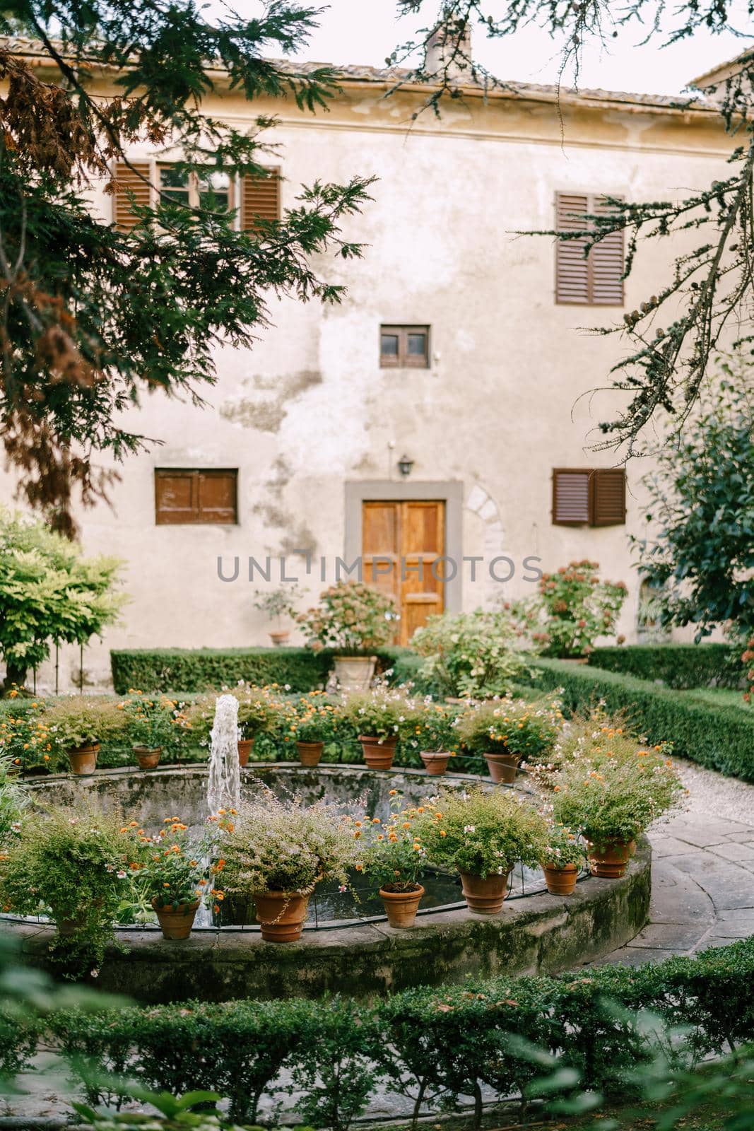 Ancient fountain in the center of the courtyard of a villa-winery in Italy, Tuscany.