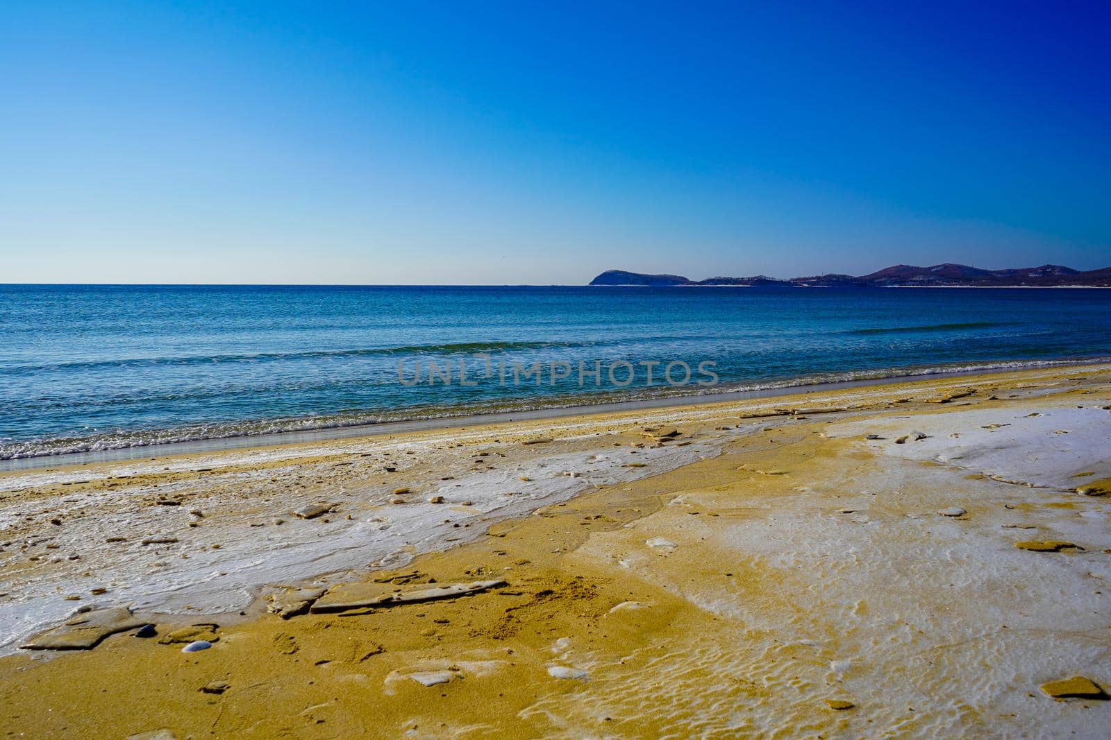 Seascape with a beach in snow.