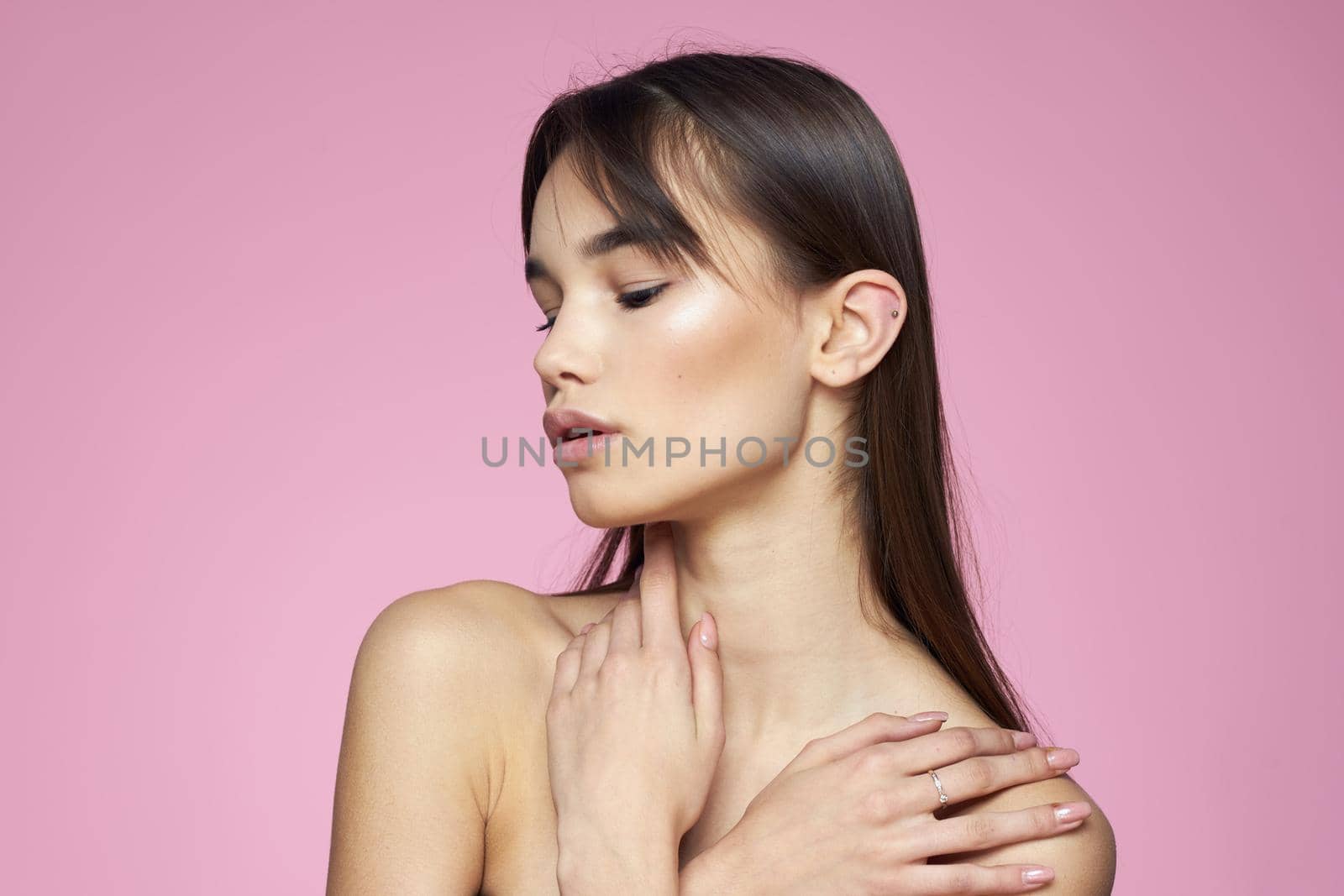 brunette bare shoulders clear skin body care pink background by SHOTPRIME