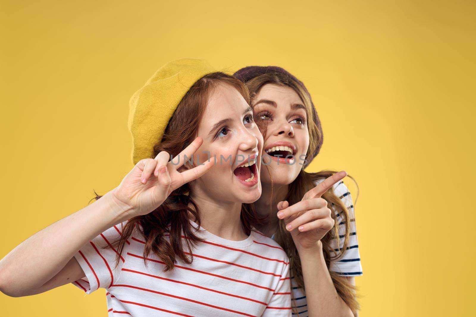 Mom and daughter embrace joy fun childhood lifestyle yellow background. High quality photo