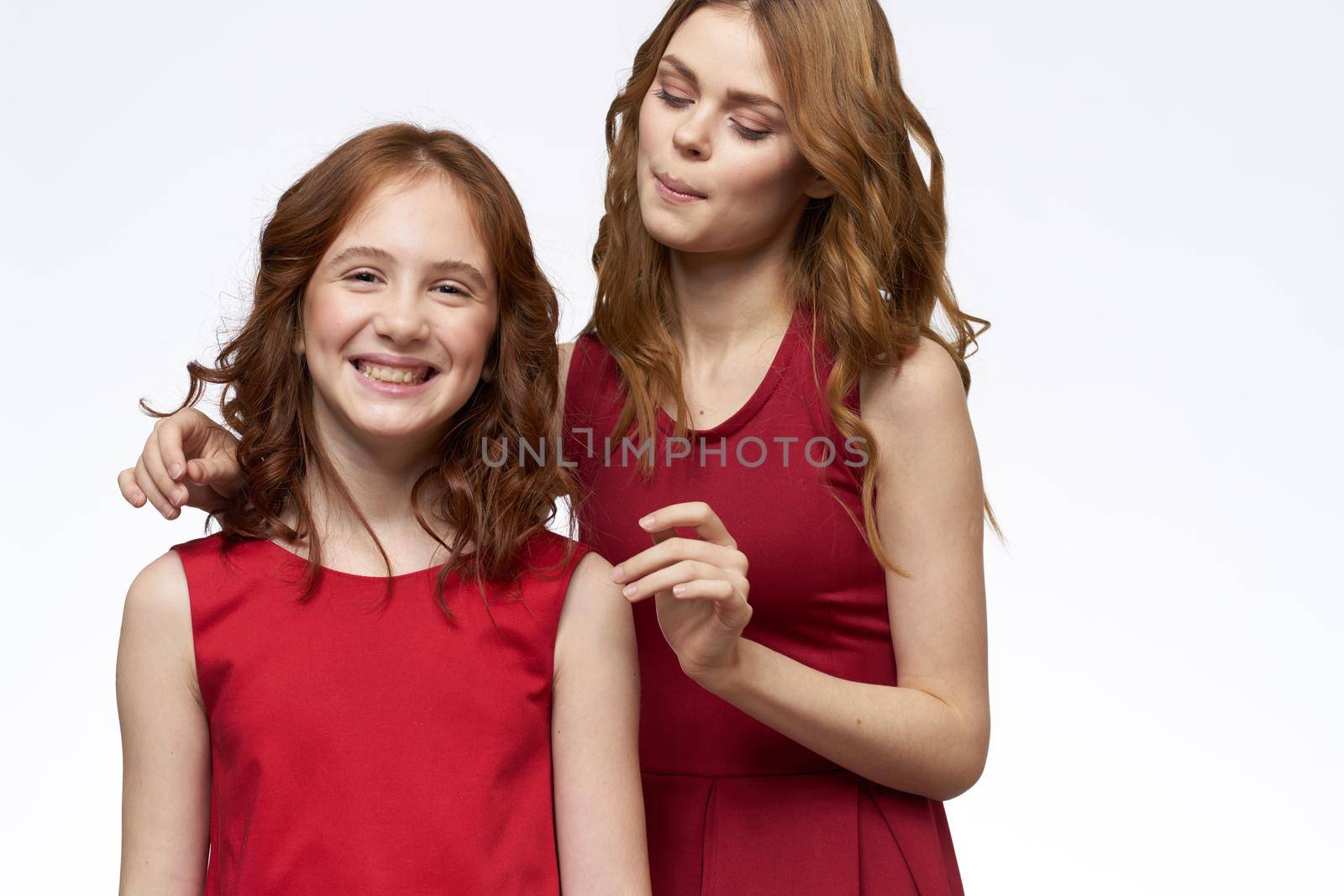 Cheerful mom and daughter hugs joy lifestyle family light background. High quality photo
