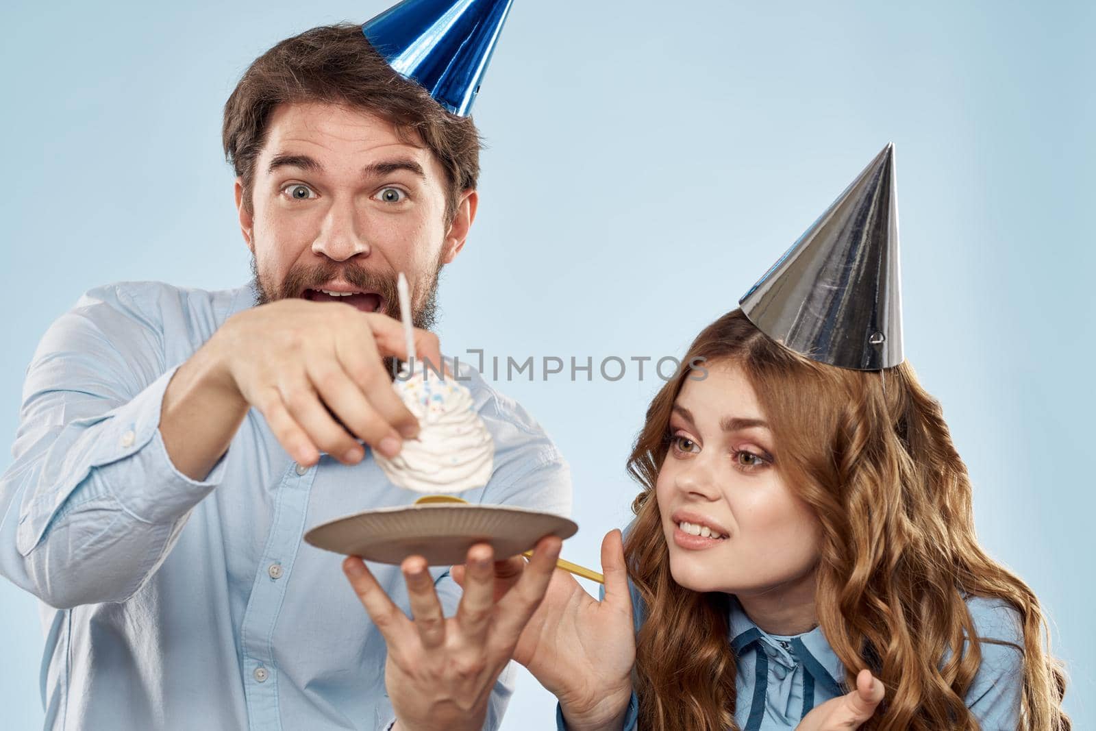 Birthday corporate young man and woman with cake on isolated background disco party. High quality photo