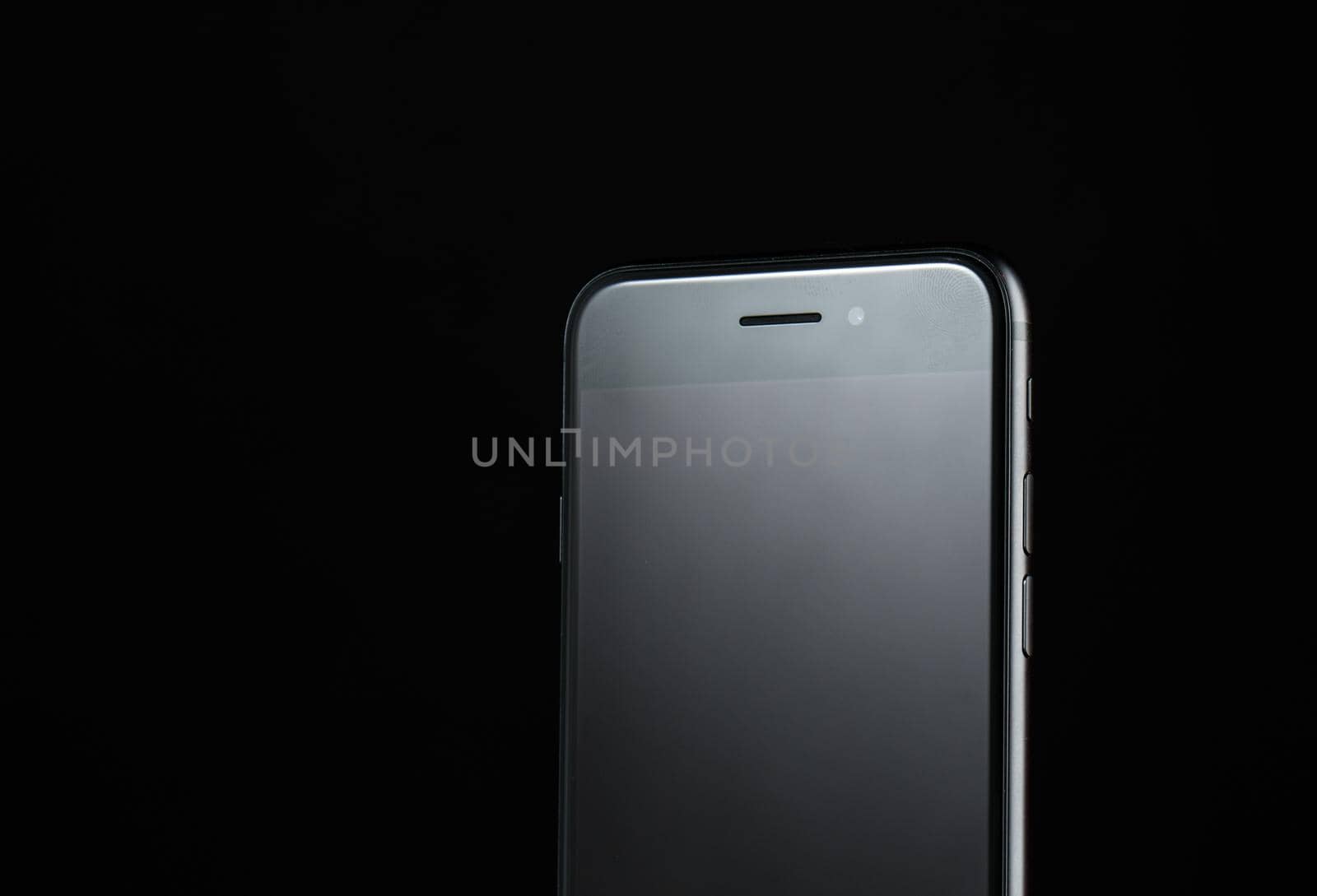 touchscreen mobile phone on black background new technologies without buttons. High quality photo