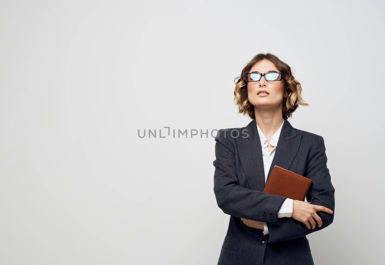 woman in classic suit documents book glasses finance business. High quality photo