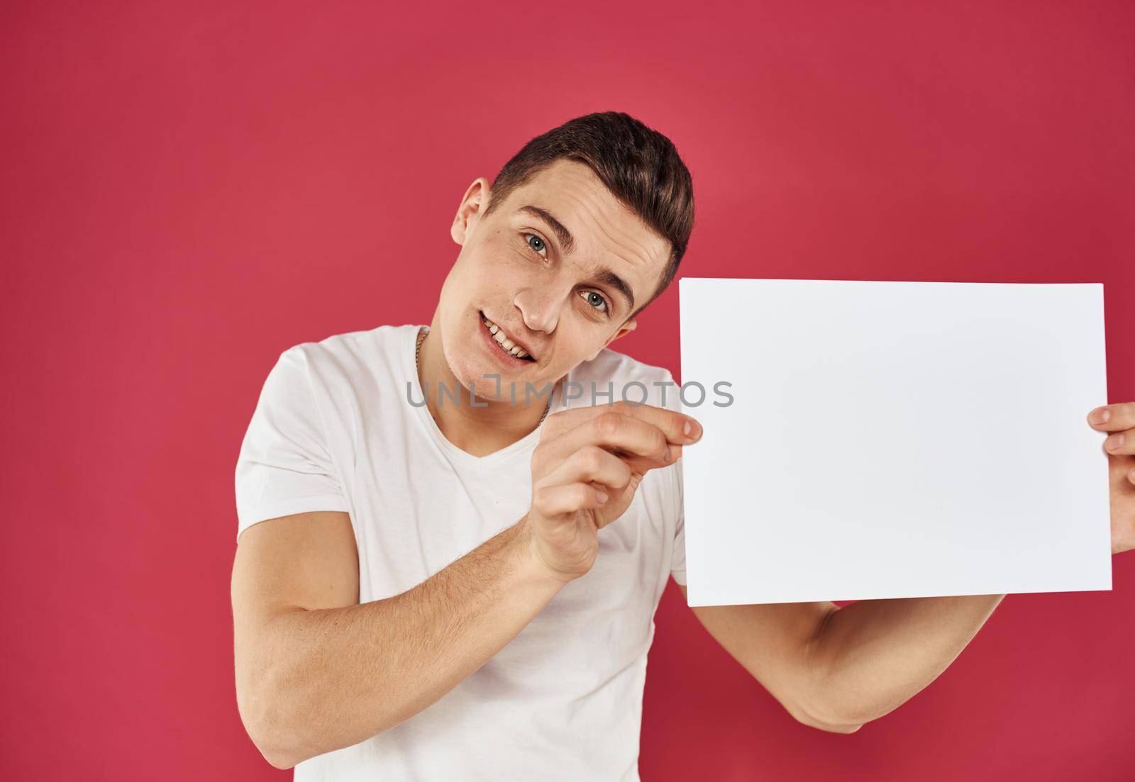 Man with a flyer in his hand on a red background advertising mockup Copy Space. High quality photo