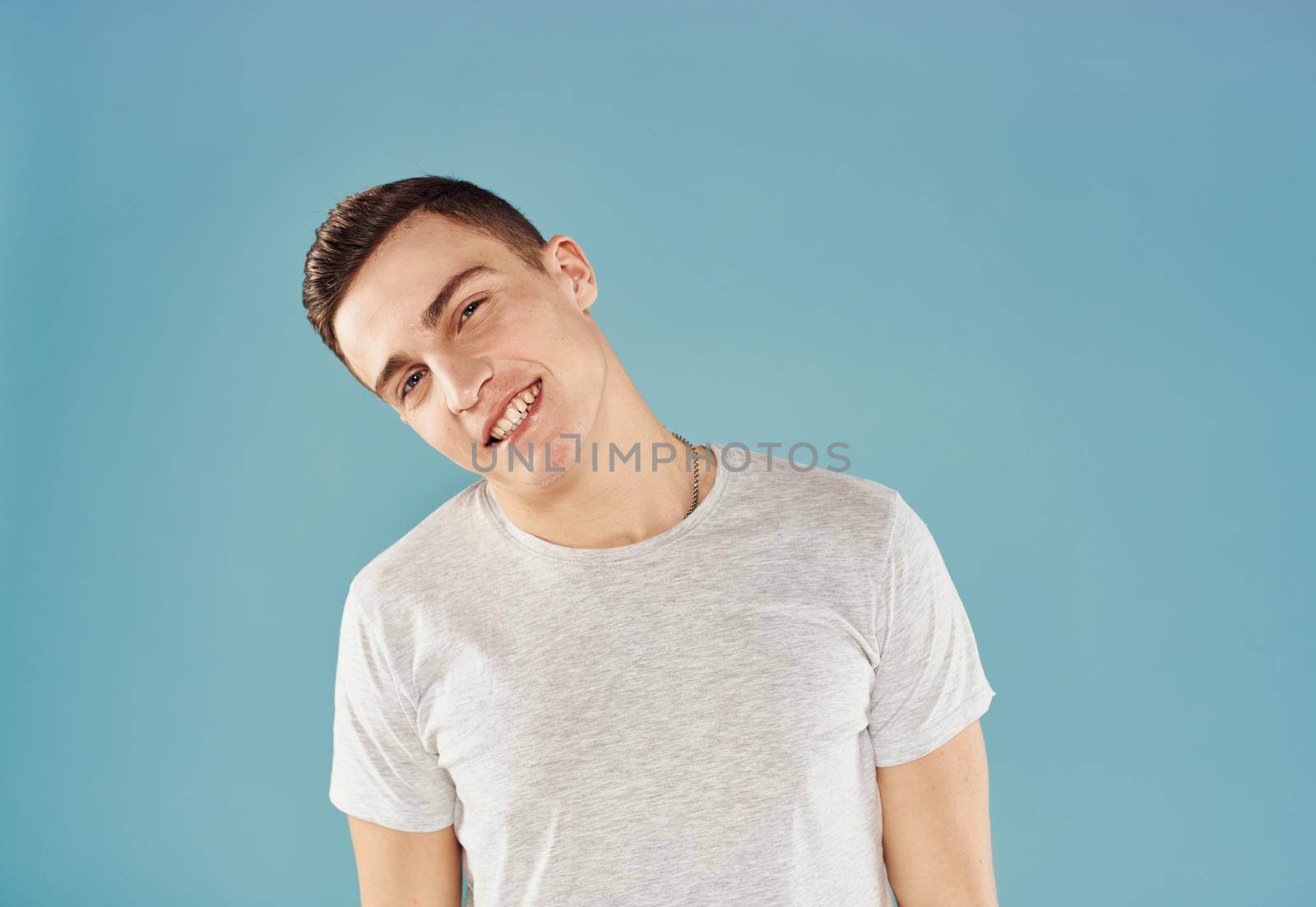 handsome man white t-shirt cropped view emotion blue background. High quality photo