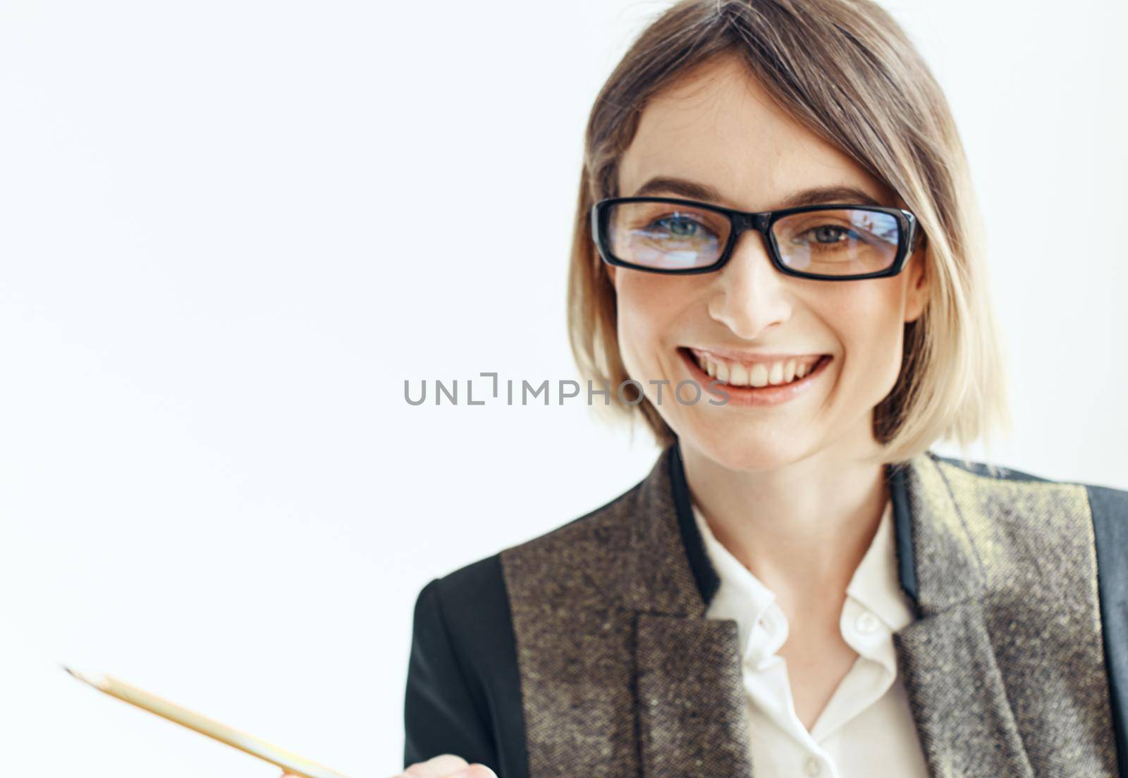 Happy woman with a pencil and glasses on a light background business finance. High quality photo