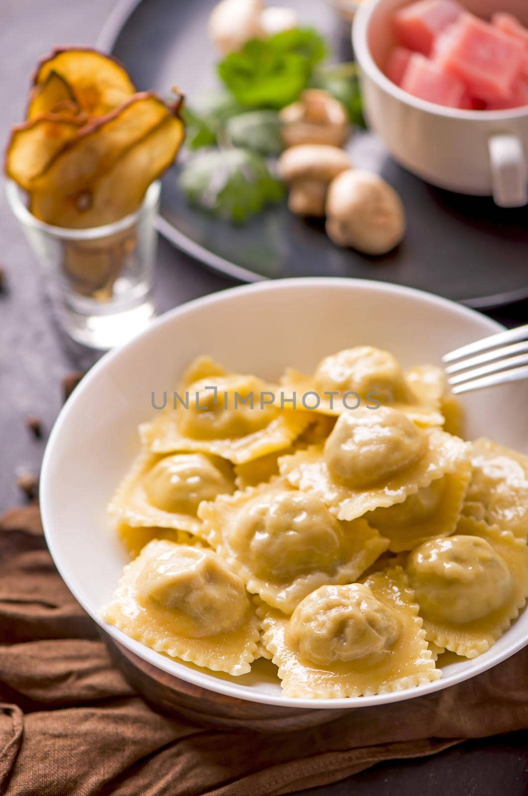 Fast food. Ravioli with spinach and ricotta cheese next to a laptop