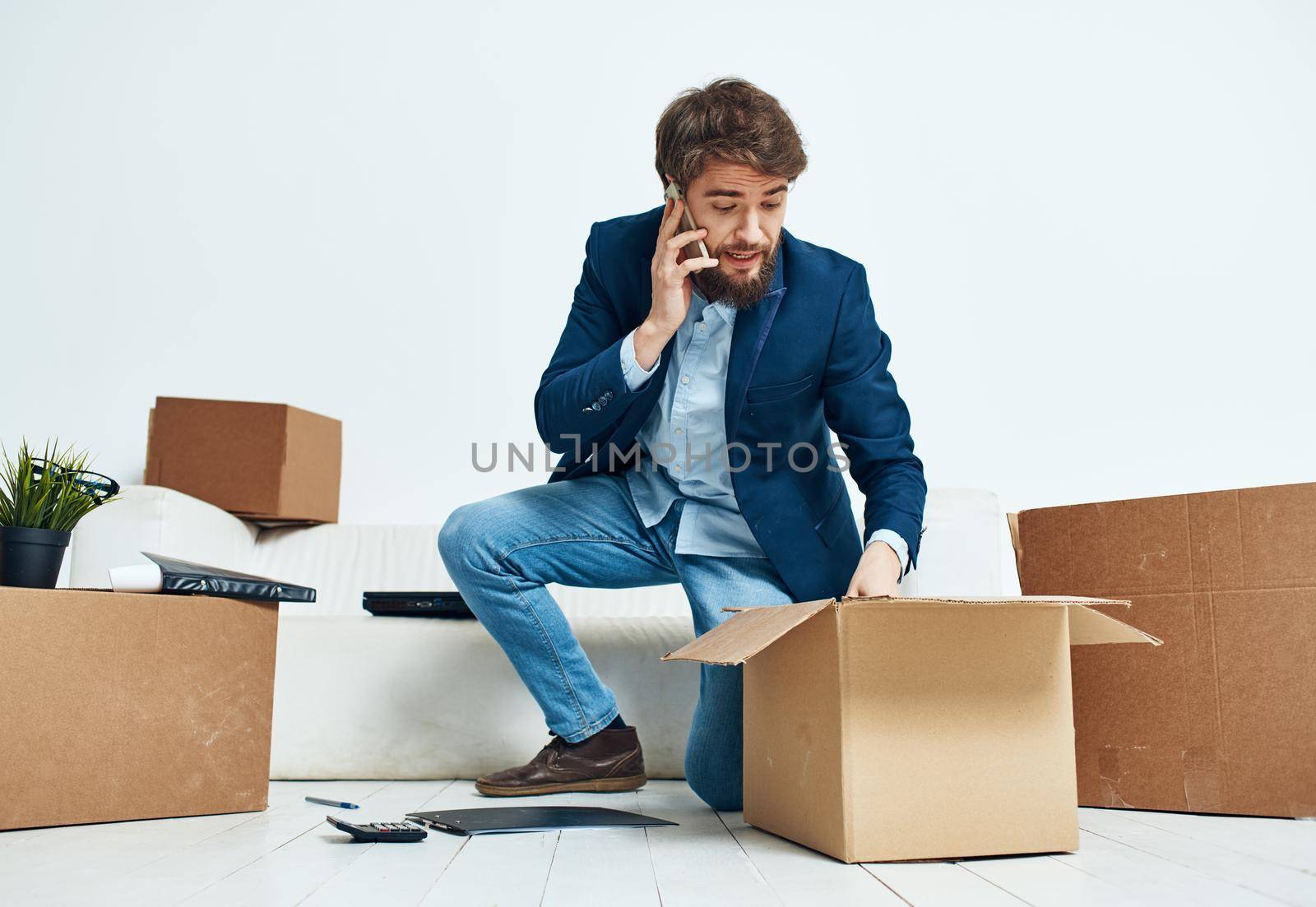 Manager talking on the phone office boxes unpacking emotions of an official. High quality photo