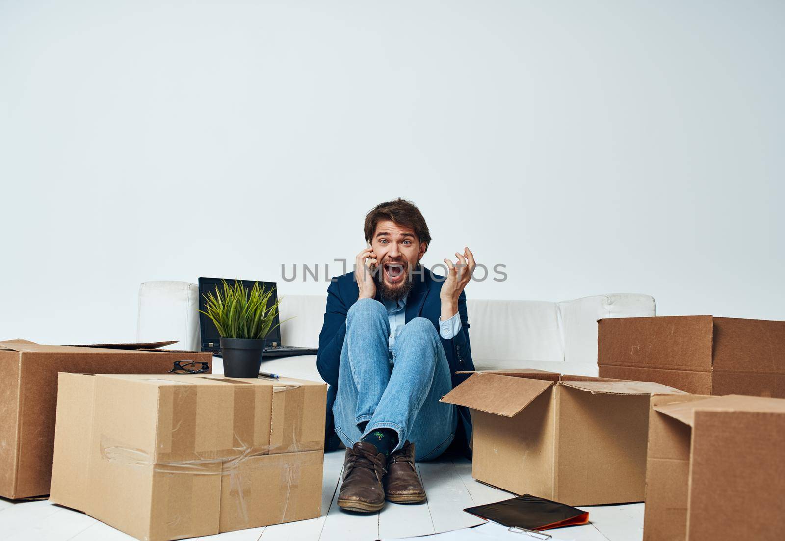 Man in a suit boxes with things moving office professional unpacking by SHOTPRIME