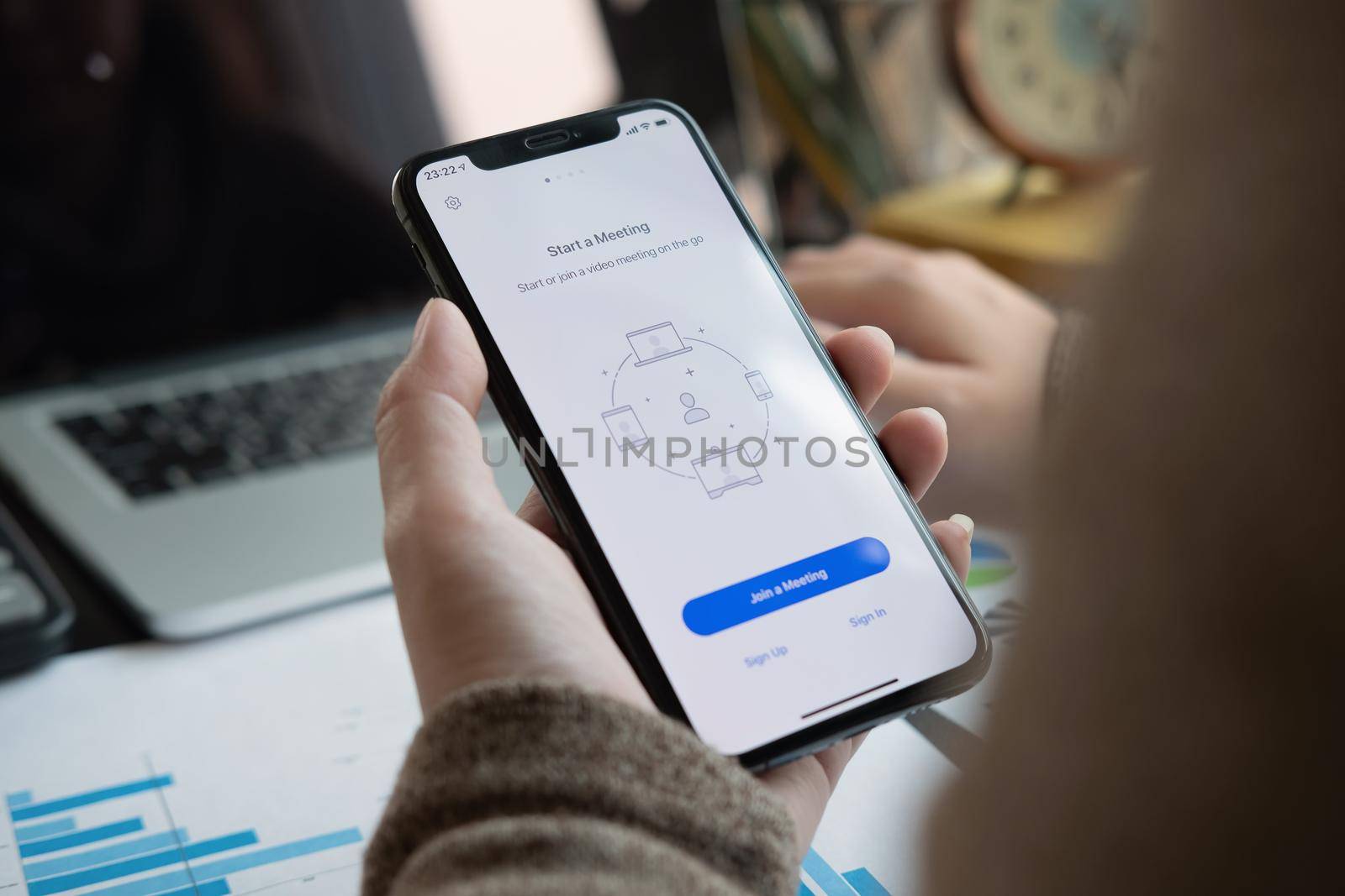 CHIANG MAI, THAILAND - APR 11, 2020 : A working from home employee is downloading the Zoom application social platform, by nateemee