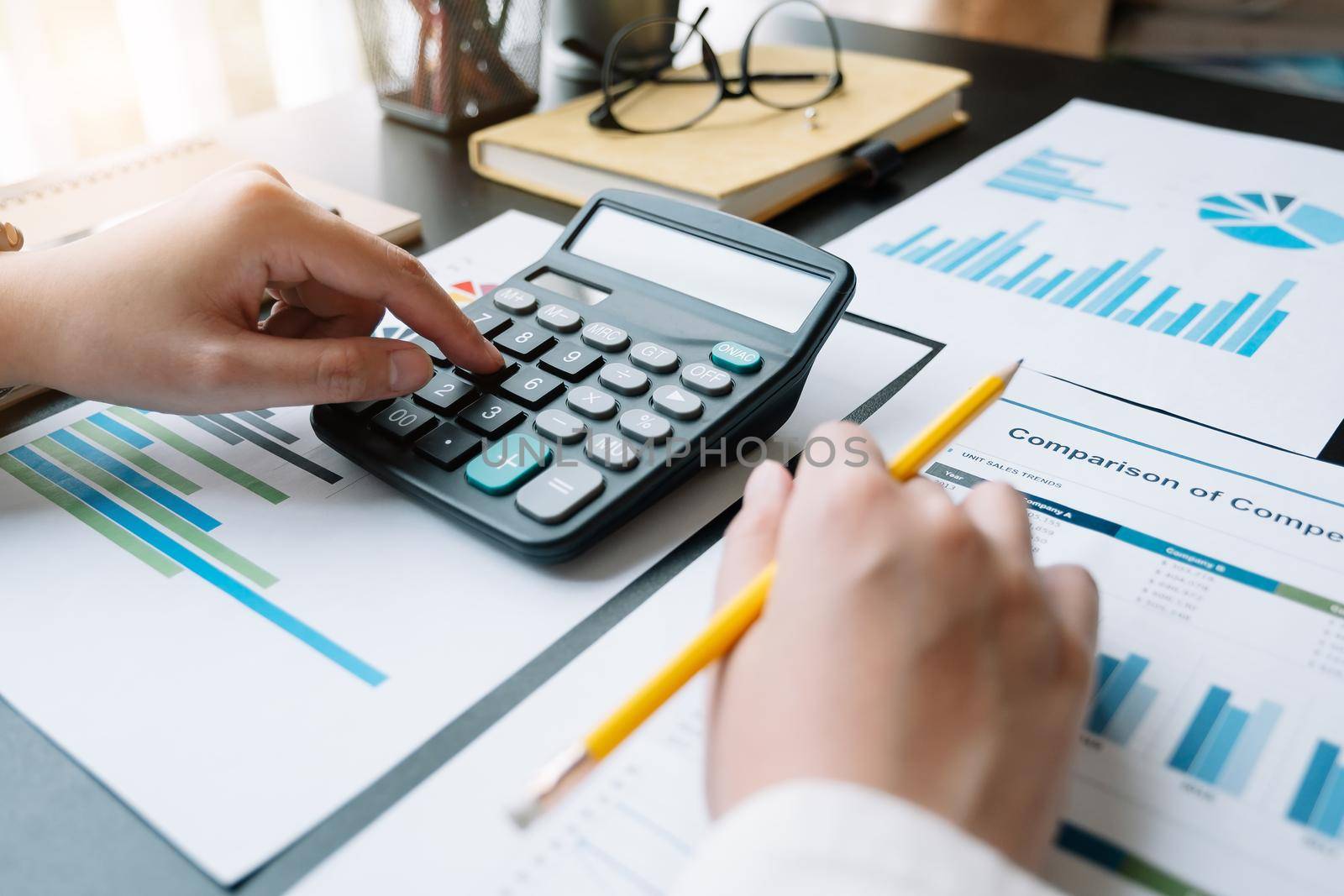 Close up a Woman working about financial with calculator at her home to calculate expenses, Accounting concept.