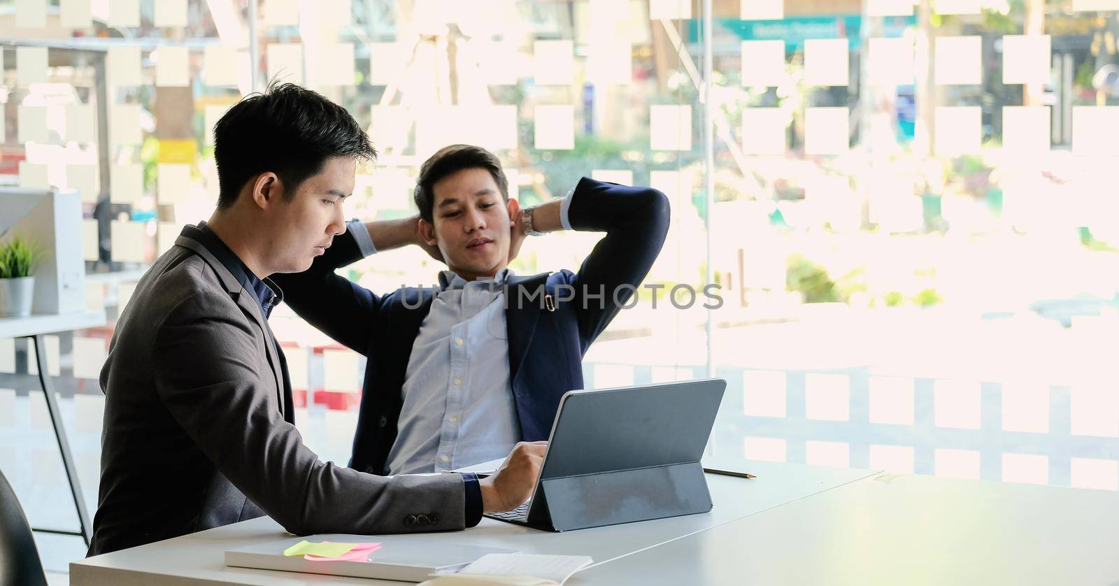 business people working on smart tablet for marketing plan together in modern office.