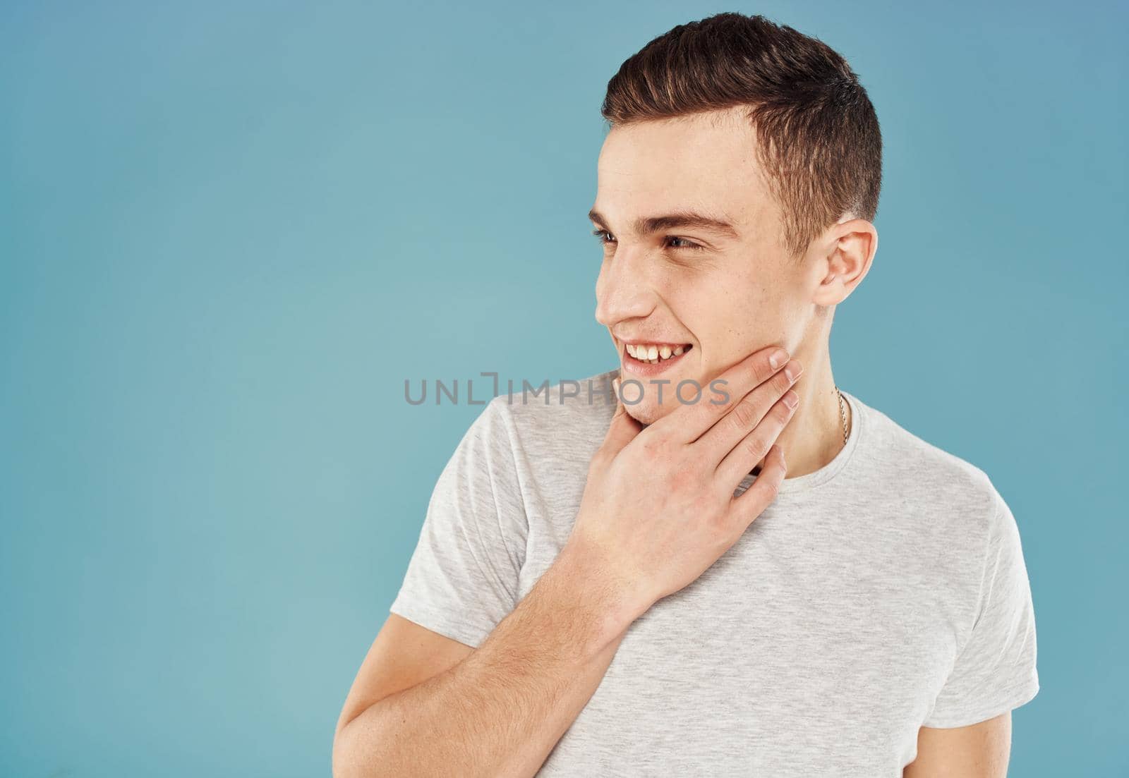 Cheerful man white t-shirt emotions cropped view blue background by SHOTPRIME