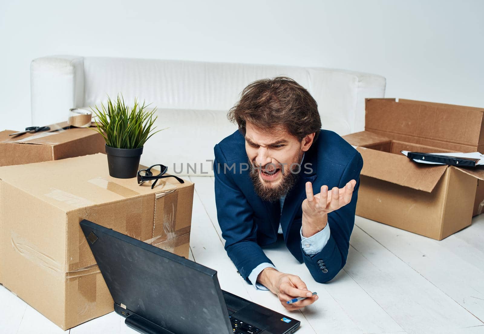 Man in suit with boxes moving laptop lifestyle Professional by SHOTPRIME