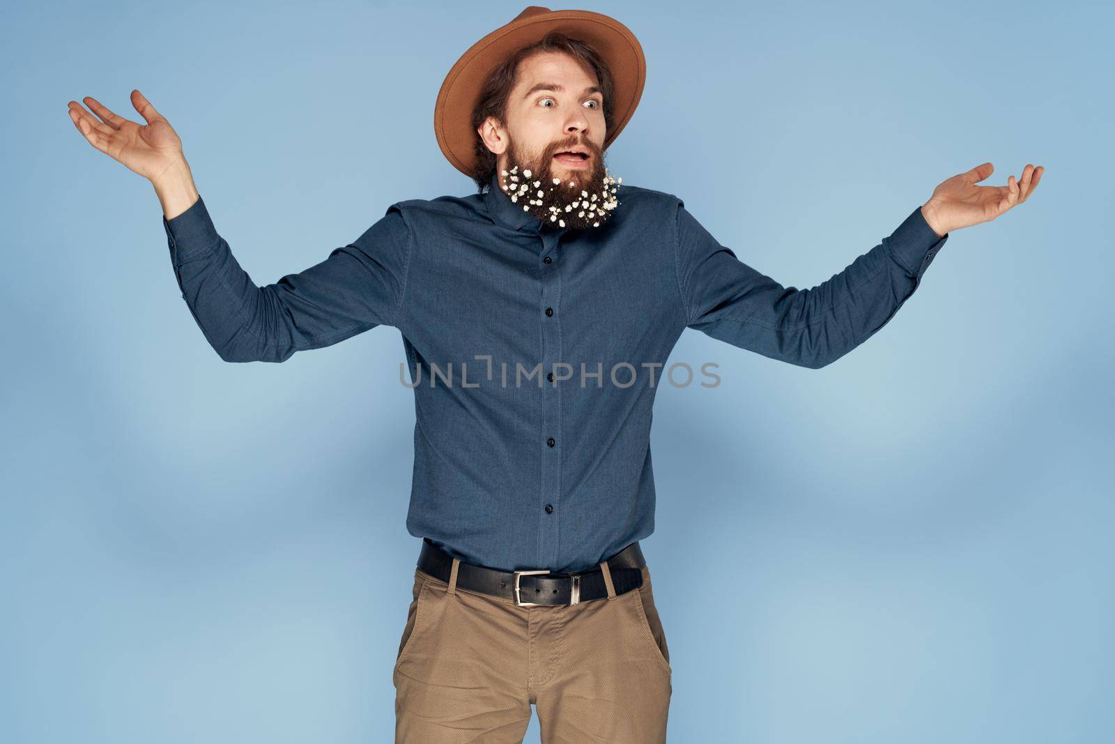 Man in hat emotions joy flowers Studio shirt fashionable clothes by SHOTPRIME