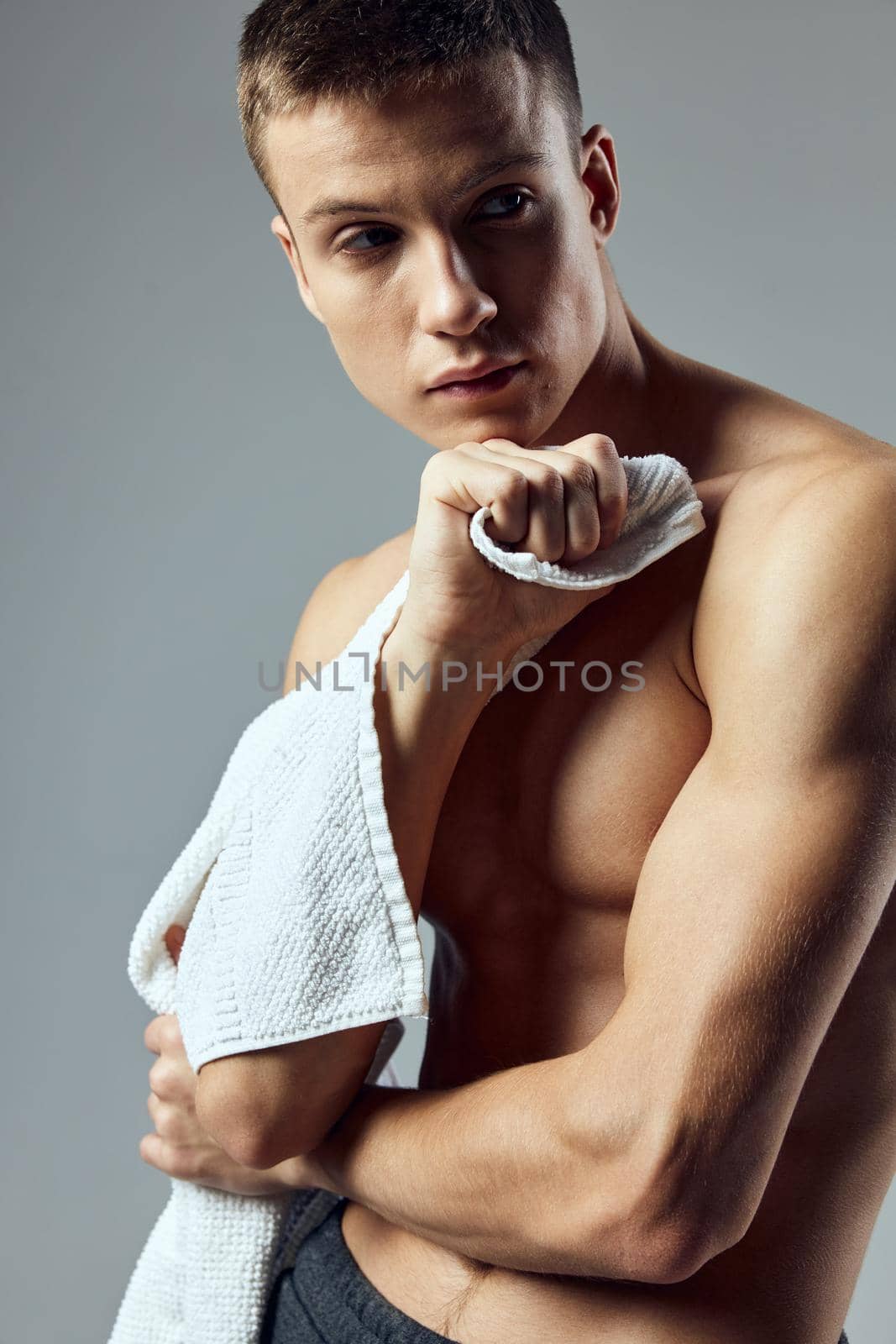 sporty man with towel in hands workout gym close-up. High quality photo
