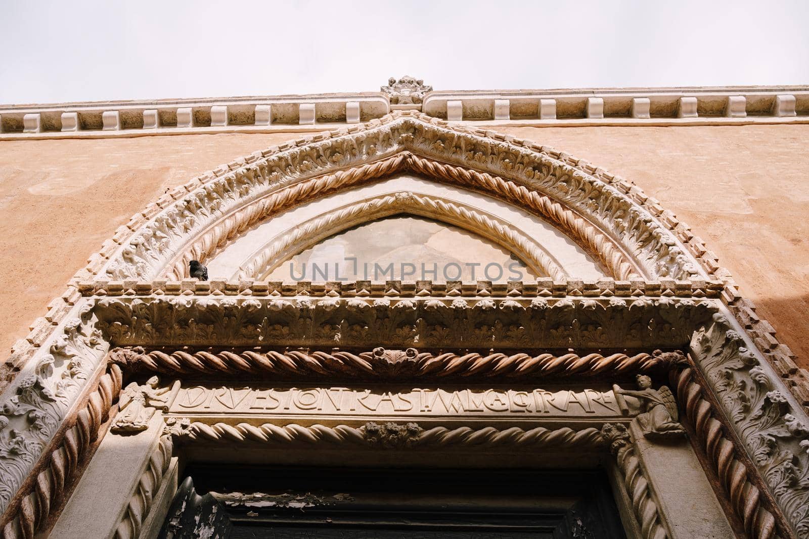 Stone spiral patterns above the doorway, bas-relief in the design of the Venetian door in Venice, Italy.