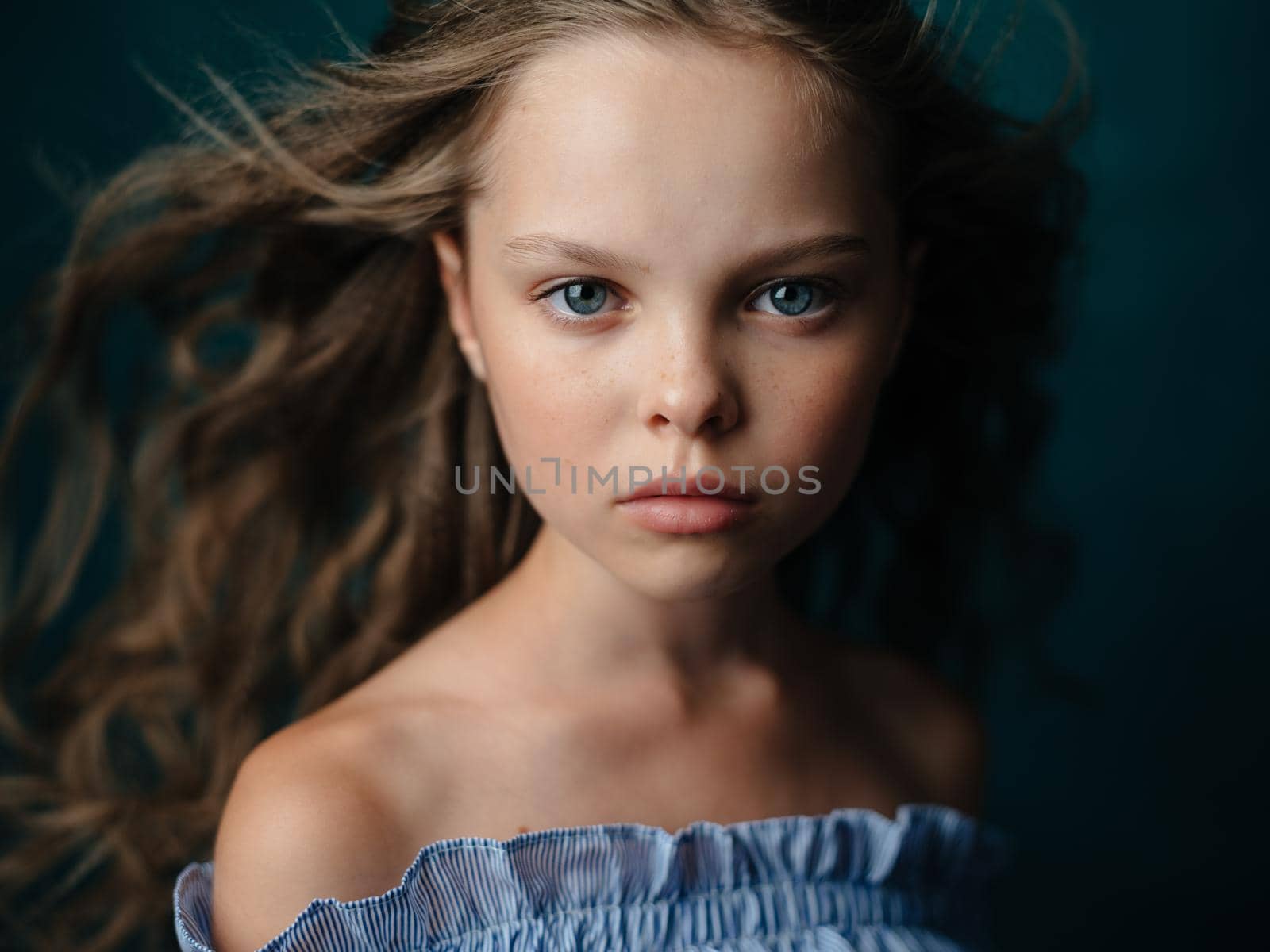 Adorable beautiful baby girl on a dark background close-up portrait cropped view. High quality photo
