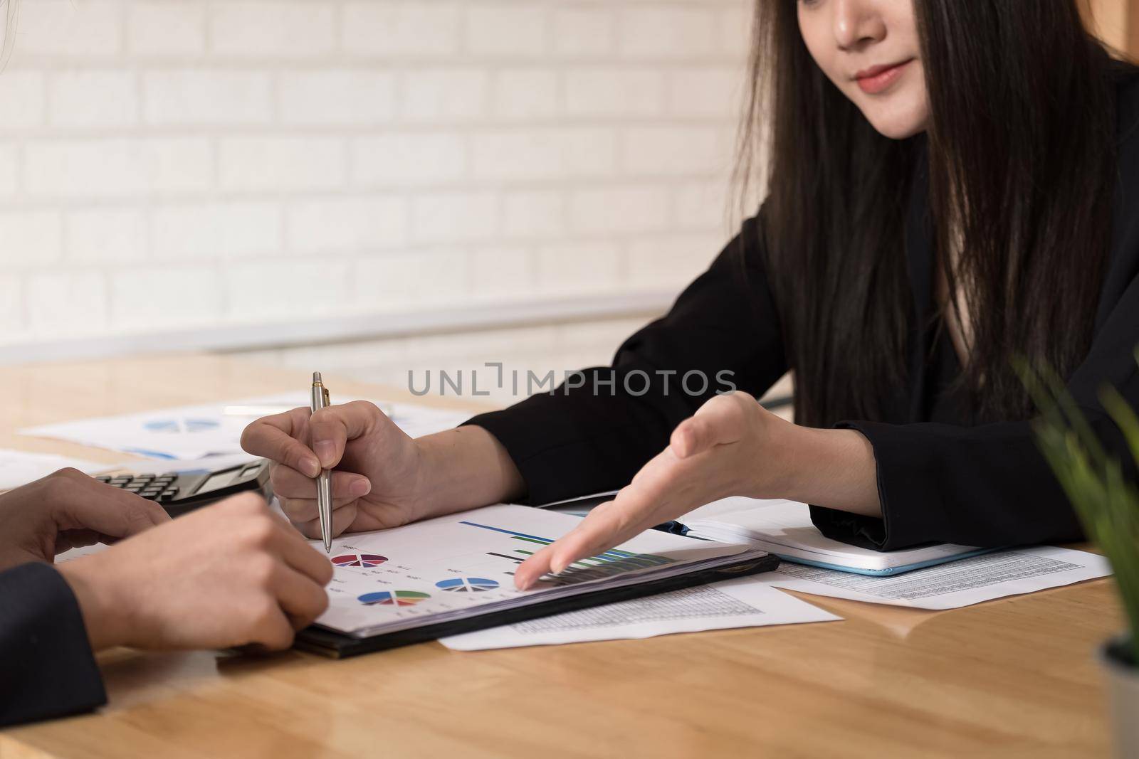 Asian business adviser meeting to analyze and discuss the situation on the financial report in the meeting room.Investment Consultant,Financial advisor and accounting concept