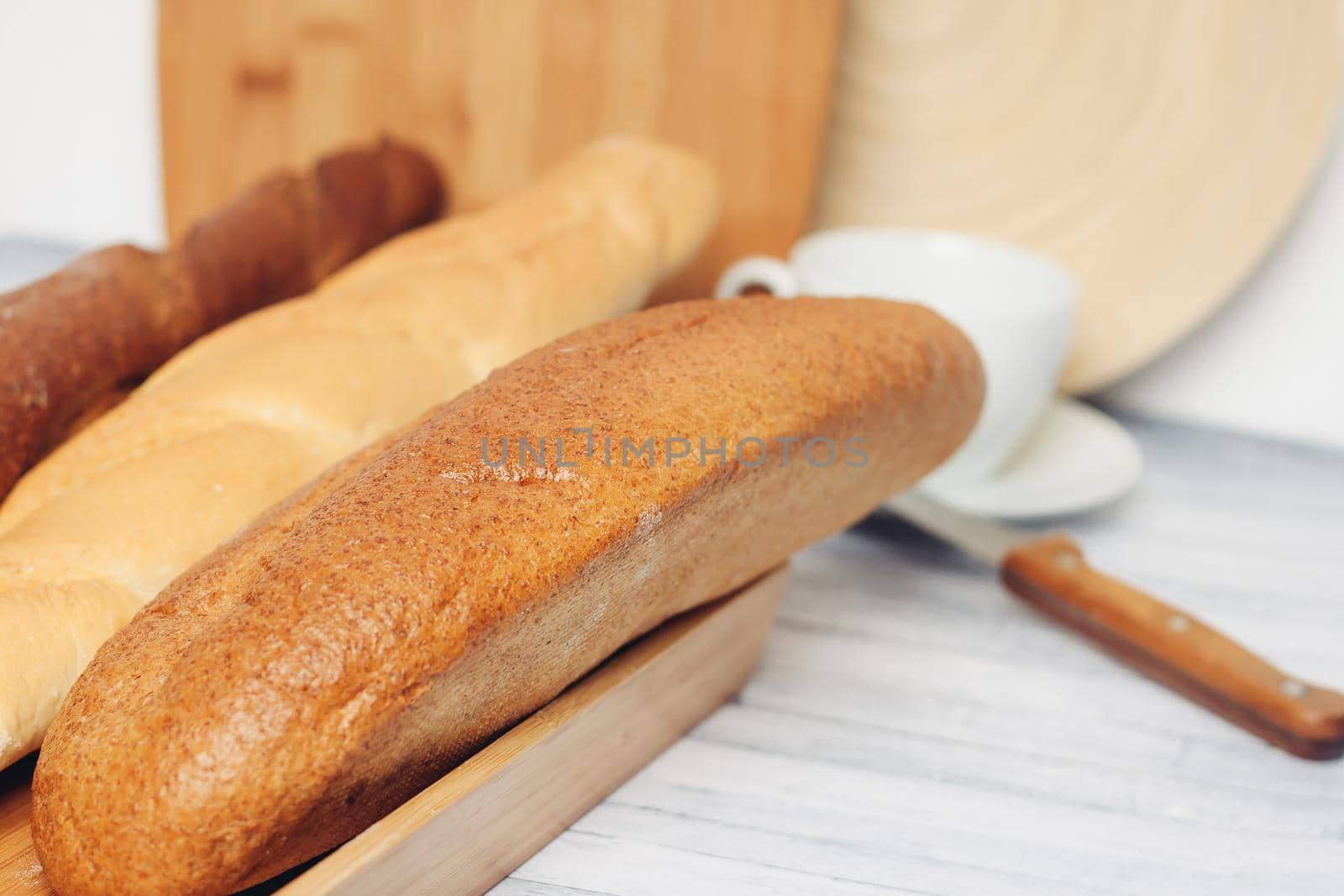 fresh loaf bread bins on the table kitchen food ration . High quality photo