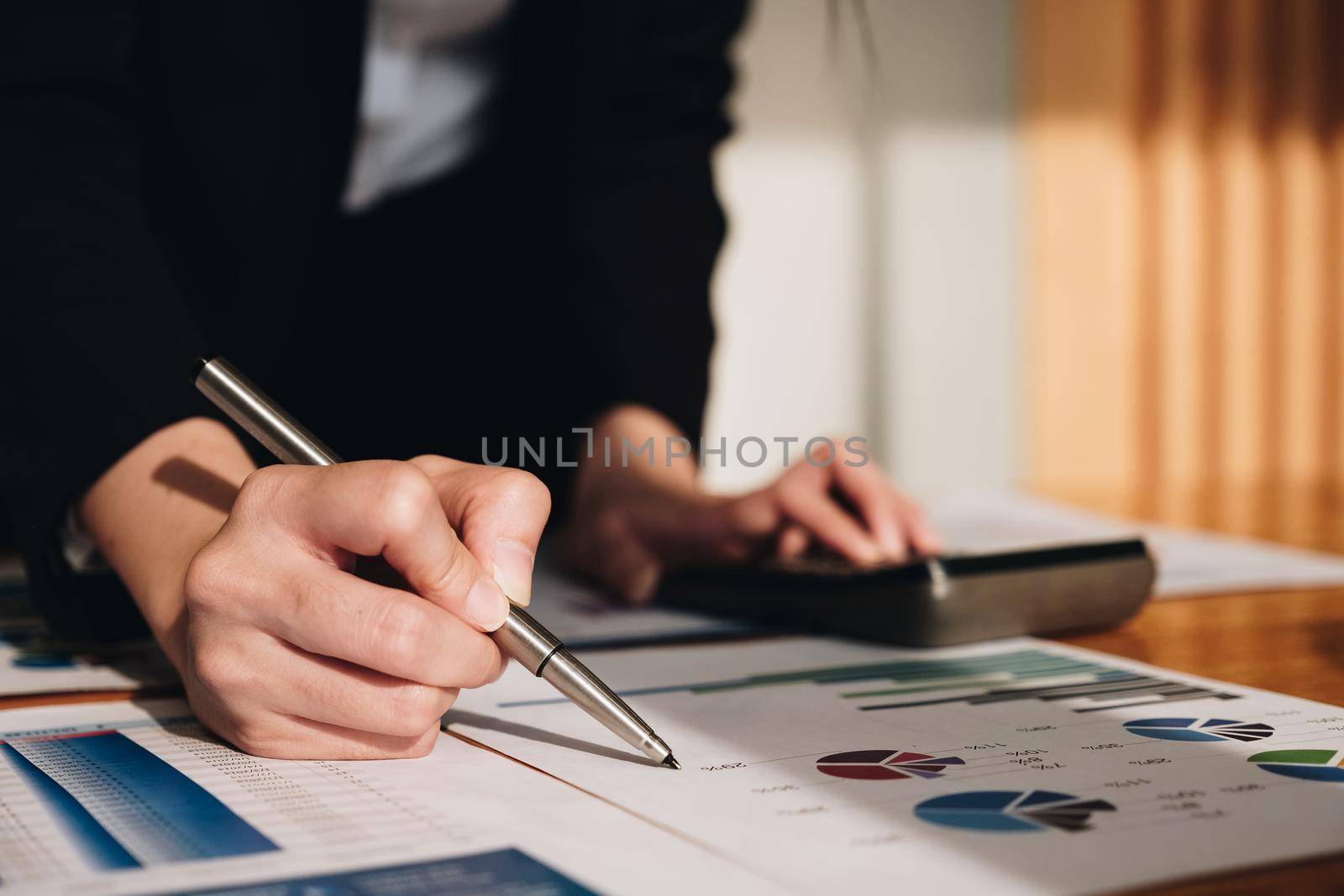 Close up Business woman using calculator for do math finance on wooden desk in office and business working background, tax, accounting, statistics and analytic research concept