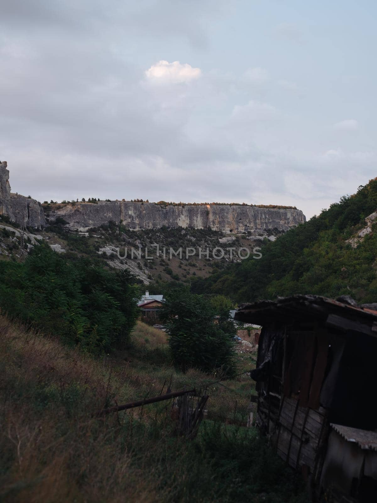 Nature mountains fresh air clouds blue sky houses in the background. High quality photo