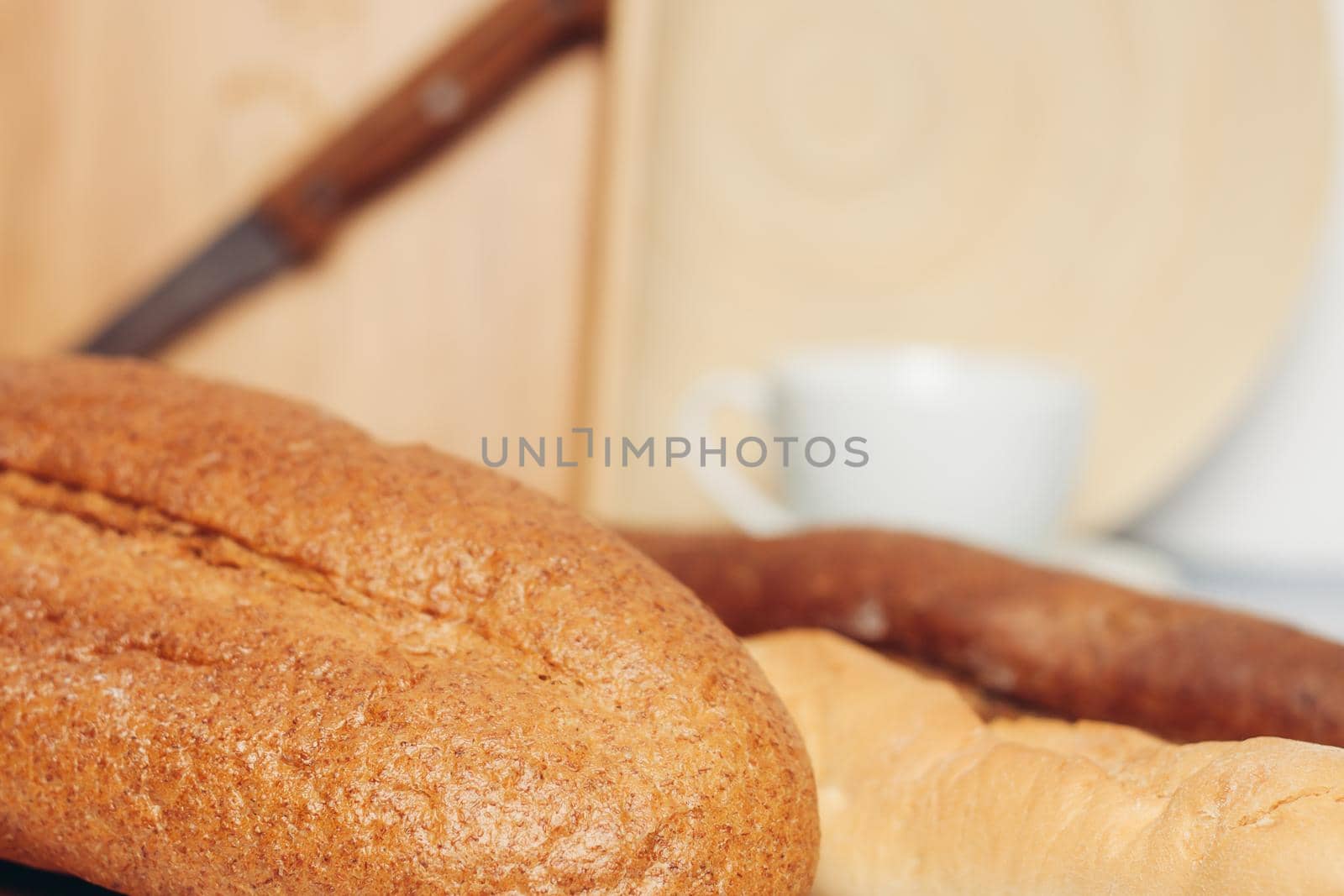 Loaf of bread cutting board spoons kitchen breakfast. High quality photo
