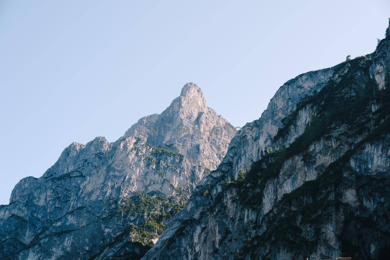 Rocky Mountains with green forests on Lago di Braies. Braies lake in the Dolomites in South Tyrol, Italy, Briesmunicipality Municipality, in the Valley of Prague.