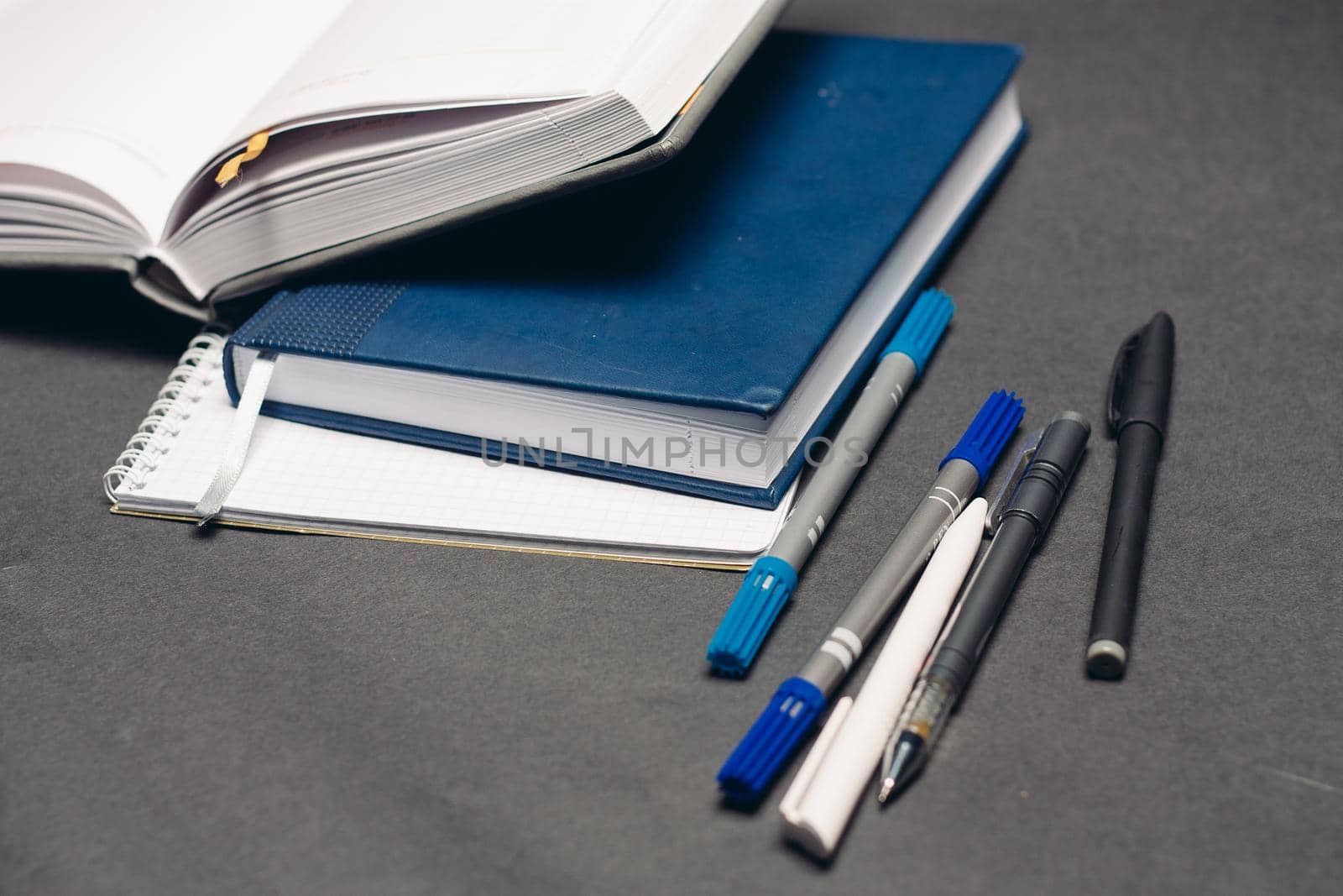 notebook and pen documents office work desk gray background. High quality photo