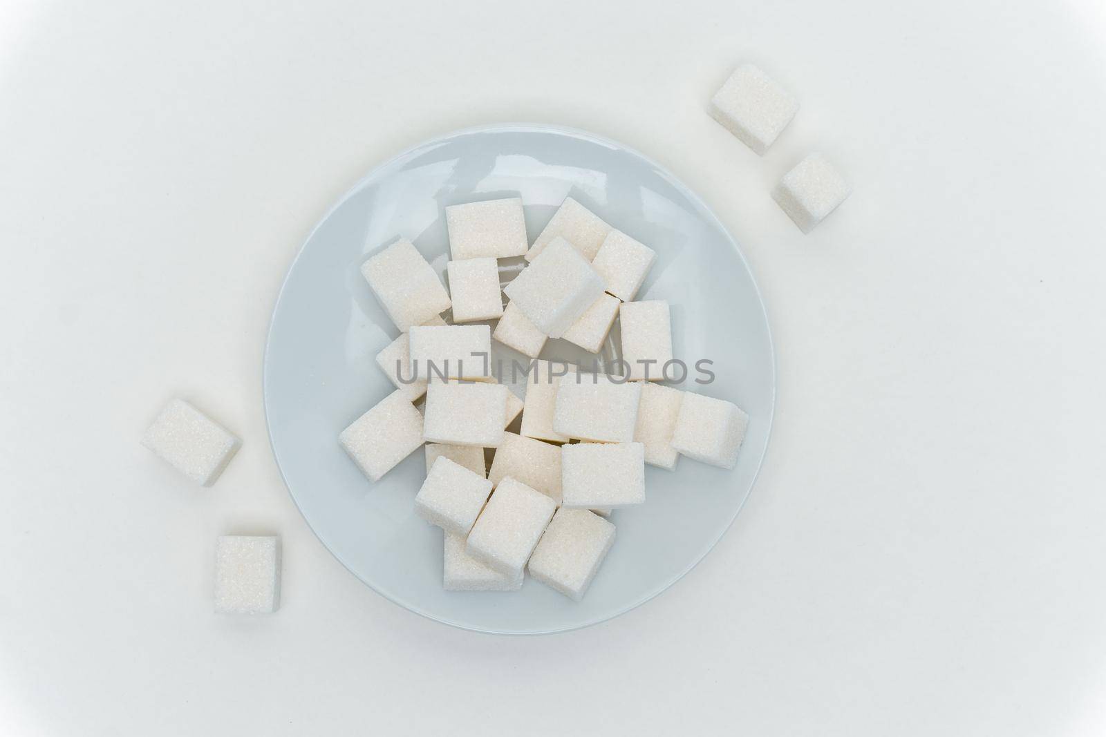 refined sugar cubes on a plate energy calories. High quality photo